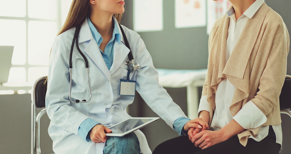 A female doctor is discussing fertility options with a female patient.