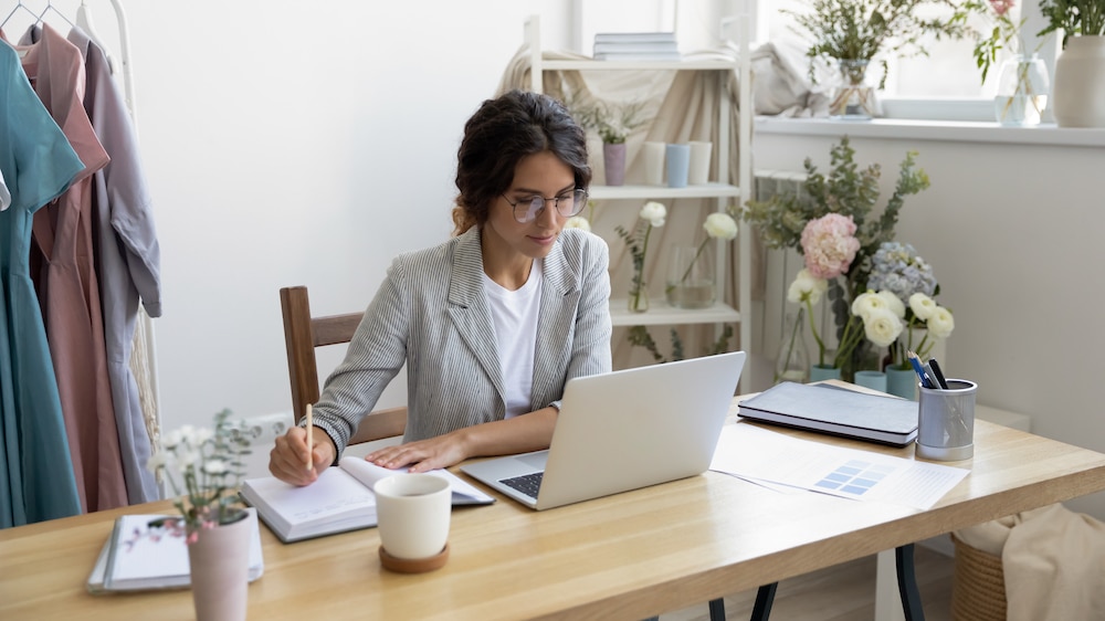 A woman engaged in family planning, working at a desk with a laptop.