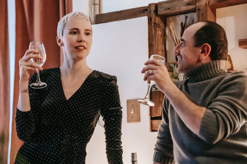 man and woman drinking wine and talking