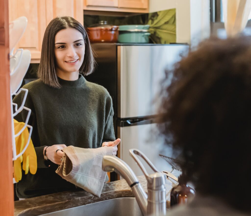 woman at sink folding towel