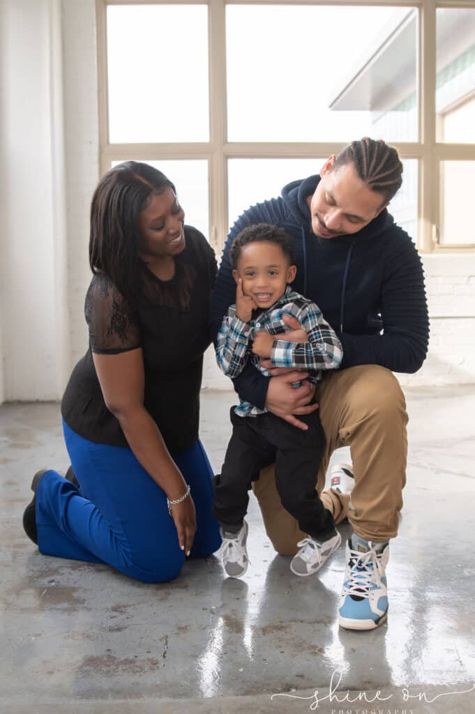 A happy family captured in an indoor studio, celebrating the birth of their IVF-conceived baby boy, with the guidance of Dr. Groll at SpringCreek Fertility Clinic in Ohio