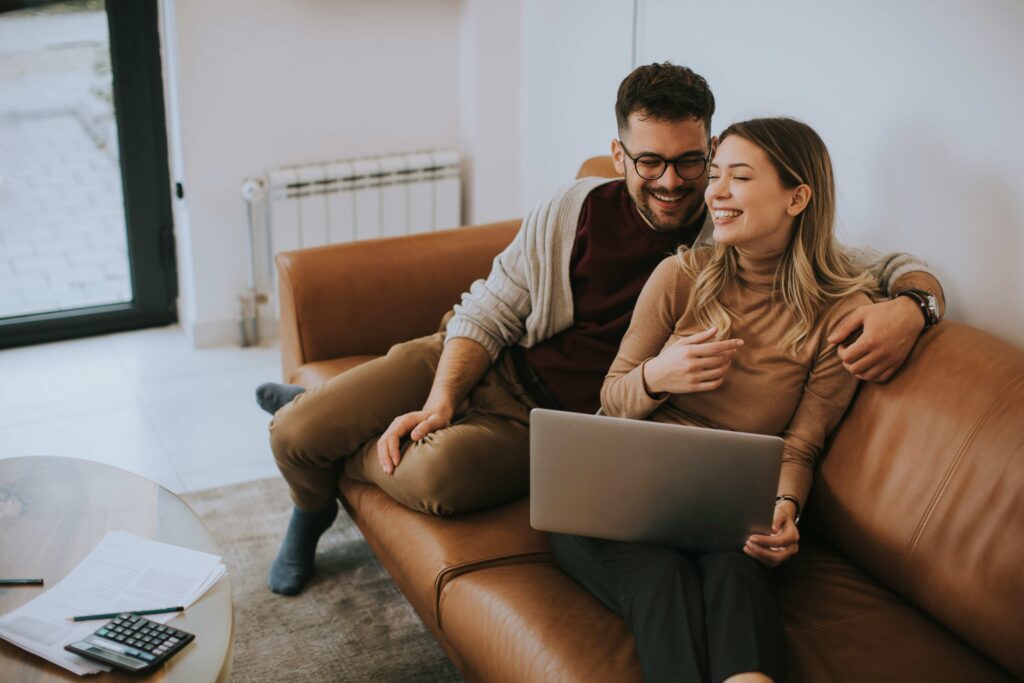 Couple comparing fertility clinics together on a laptop
