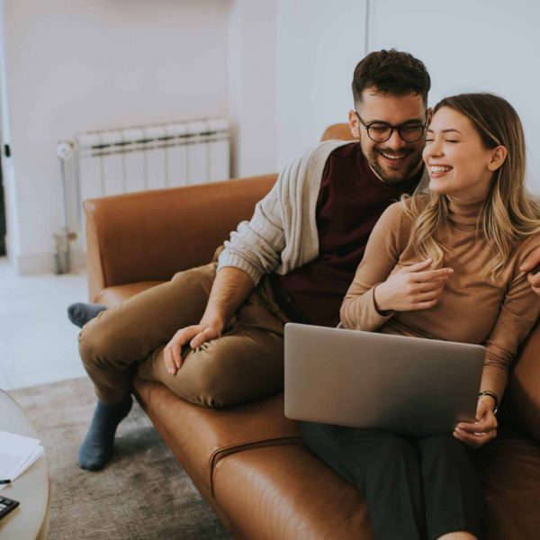Couple comparing fertility clinics together on a laptop