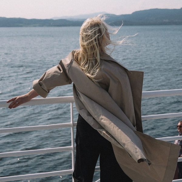 A woman with a chronic condition is standing on the deck of a boat, seeking care and education.