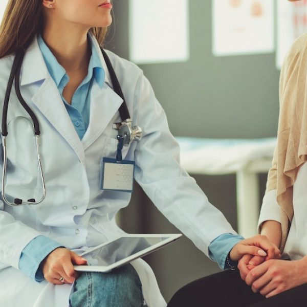 A female doctor is discussing fertility options with a female patient.