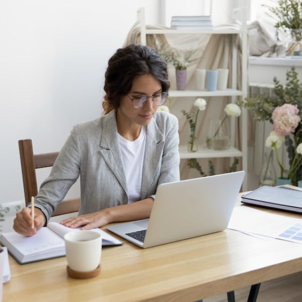 A woman engaged in family planning, working at a desk with a laptop.